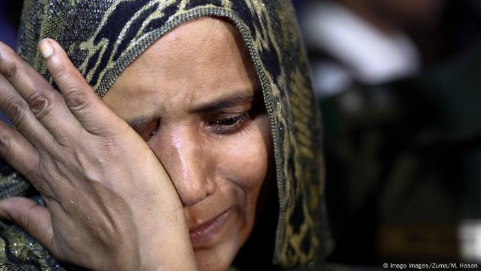 A Bangladeshi woman wiping tears from her eyes