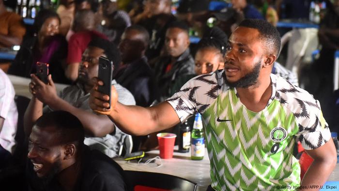 Young football fans in Nigeria with their smartphones