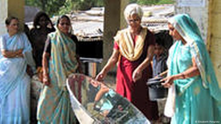 Washing a Large Cooking Pot in an Ashram (India)