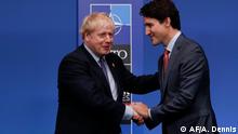 Britain's Prime Minister Boris Johnson (L) shakes hands with Canada's Prime Minister Justin Trudeau upon arrival for the NATO summit at the Grove hotel in Watford, northeast of London on December 4, 2019. (Photo by Adrian DENNIS / AFP)