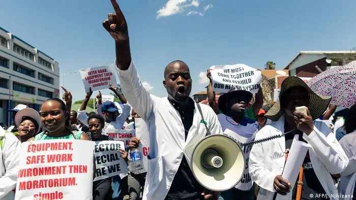 A doctor with a loud hailer shouts slogans during a protest march by senior medical doctors in Harare