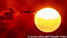 FILE - In this Wednesday, Aug. 21, 2019 file photo, an aircraft passes the rising sun as it approaches the airport in Frankfurt, Germany. The European Union says it will miss its targets for reducing planet-warming greenhouse gases by 2030 unless member states make a greater effort than they have so far. (AP Photo/Michael Probst, File) |