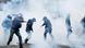 Masked protesters throw objects amid tear gas in Paris Masked protesters throw objects amid tear gas in Paris