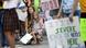 Emily Hill and her daughter Josephine Hill, 6, of Bellevue, Neb.,listen to speakers during a youth climate strike week action in Omaha, Nebraska Emily Hill and her daughter Josephine Hill, 6, of Bellevue, Neb.,listen to speakers during a youth climate strike week action in Omaha, Nebraska