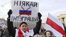A protester holds a banner reading