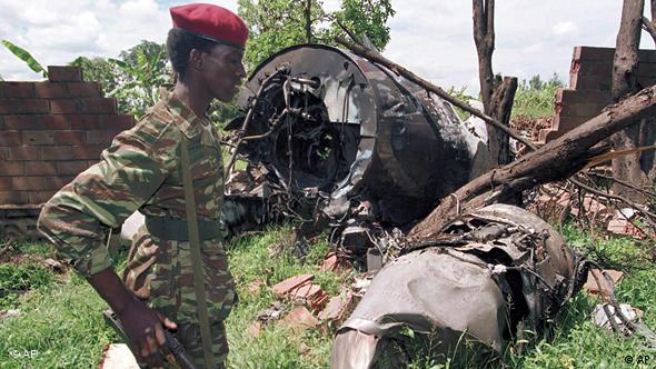 A soldier looks on at the wreckage of a plane 