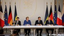 (FromL) Ukrainian President Volodymyr Zelensky, German Chancellor Angela Merkel, French President Emmanuel Macron and Russian President Vladimir Putin give a press conference after a summit on Ukraine at the Elysee Palace, in Paris, on December 9, 2019. (Photo by ludovic MARIN / POOL / AFP)