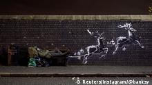 A man lays on a bench next to a new mural by Banksy in Birmingham, Britain, December 9, 2019, in this picture obtained from social media. @banksy/Instagram via REUTERS THIS IMAGE HAS BEEN SUPPLIED BY A THIRD PARTY. MANDATORY CREDIT. NO RESALES. NO ARCHIVES.