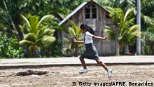 An indigenous girl from the Amazonian province of Bretana runs home from school in Loreto, Peru on October 23, 2012. Teachers will instruct indigenous children of the region in their own language, as well as Spanish, as part of an aggressive government policy to reduce illiteracy and promote bilingual intercultural education in native communities. AFP PHOTO/ERNESTO BENAVIDES (Photo credit should read ERNESTO BENAVIDES/AFP via Getty Images)