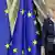 Ursula von der Leyen stands next to EU flags at the EU summit