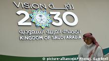 A Saudi man walks past a Vision 2030 display at a stand about Saudi Arabia during the World Energy Congress in Abu Dhabi, United Arab Emirates, Tuesday, Sept. 10, 2019. Amin Nasser, the chairman and CEO of the state-run oil giant Saudi Aramco, told journalists Tuesday a planned initial public offering of a sliver of the company's worth would happen very soon. Vision 2030 is an ambitious plan by Saudi Arabia's Crown Prince Mohammed bin Salman that includes the IPO of a small part of Saudi Aramco to help fund its efforts. (AP Photo/Jon Gambrell) |