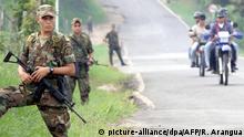 Colombian Army soldiers patrol the sreets of Paujil, near Caqueta, Colombia, 21 February, 2002, near the area controlled by the Revolutionary Armed Forces of Colombia (FARC). Colombia's military launched a major offensive to reclaim the Switzerland-sized swath of territory controlled by the country's largest insurgency, hours after President Andres Pastrana called off peace talks with the rebels. Military aircraft dropped bombs on 85 targets inside the area controlled by the Revolutionary Armed Forces of Colombia (FARC), military sources announced. dpa |