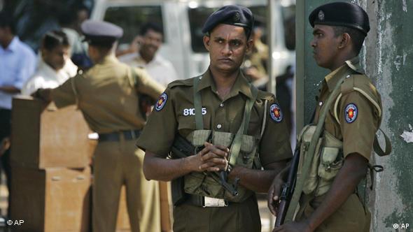 Sri Lankan police officers stand guard at a poll