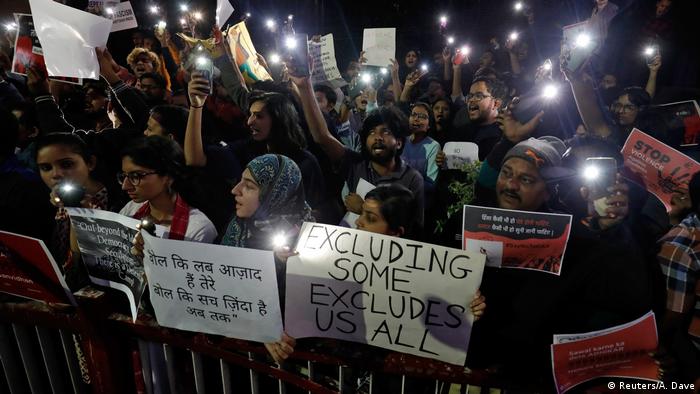 Student protesters hold signs in New Delhi