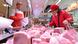A woman buys pork at a supermarket in Nanchang, China A woman buys pork at a supermarket in Nanchang, China