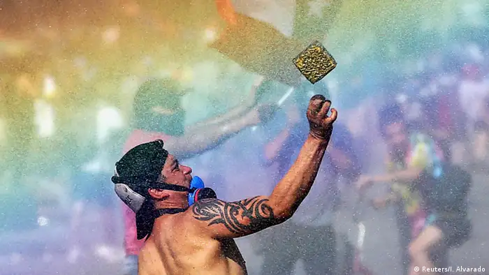 A rainbow is seen as demonstrators protest against Chile's state economic model in Santiago, Chile October 24, 2019. (REUTERS/Ivan Alvarado)