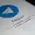 Логотип мессенджера Telegram на экране смартфона