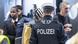 A federal police officer checks a traveler's documents at Frankfurt Airport A federal police officer checks a traveler's documents at Frankfurt Airport