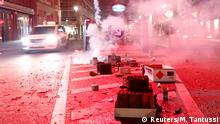 Smoke from fireworks shroud garbage on a street near Berlin Friedrichstrasse station during New Year celebrations in Berlin, Germany January 1, 2020. REUTERS/Michele Tantussi