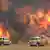 Firetrucks in front of huge flames (AP/Twitter@NSWRFS)