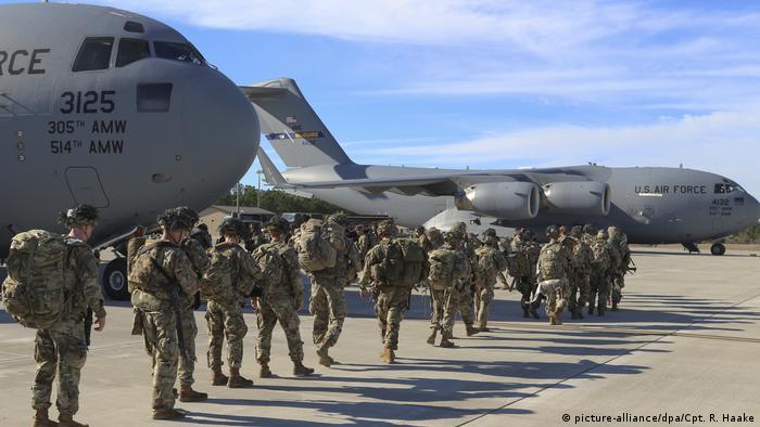 US soliders walking towards a military plane