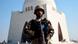 Pakistani army: Pakistani soldier standing in front of a mosque in Karachi Pakistani army: Pakistani soldier standing in front of a mosque in Karachi