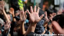 05.01.2020 *** Protesters raise their hands to symbolize the five demands of the pro democracy movement during a demonstration against parallel traders who buy goods in Hong Kong to resell in mainland China in Sheung Shui, near the Chinese border in Hong Kong, Sunday, Jan. 5, 2020. Protesters in Hong Kong marched through the border town Sunday to oppose traders from mainland China. (AP Photo/Andy Wong)