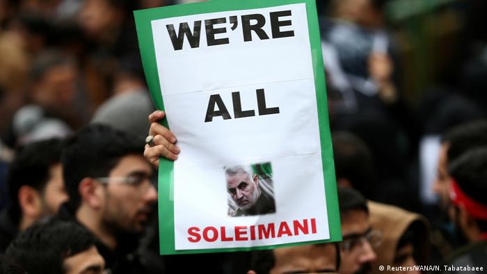 An Iranian man holds up a sign saying We're all Soleimani (Reuters/WANA/N. Tabatabaee)