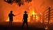 Residents defend a property from a bushfire at Hillsville near Taree, 350km north of Sydney. Residents defend a property from a bushfire at Hillsville near Taree, 350km north of Sydney.