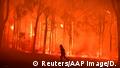 NSW Fire and Rescue officer protects the Colo Heights Public School from being impacted by the Gospers Mountain fire near Colo Heights south west of Sydney, Australia, November 19, 2019. AAP Image/Dean Lewins/via REUTERS ATTENTION EDITORS - THIS IMAGE WAS PROVIDED BY A THIRD PARTY. NO RESALES. NO ARCHIVE. AUSTRALIA OUT. NEW ZEALAND OUT. NO COMMERCIAL OR EDITORIAL SALES IN NEW ZEALAND. NO COMMERCIAL OR EDITORIAL SALES IN AUSTRALIA. TPX IMAGES OF THE DAY