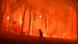 A firefighter is seen running in a burning forest A firefighter is seen running in a burning forest
