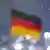 German flag is pictured through a wet window in Berlin, Germany