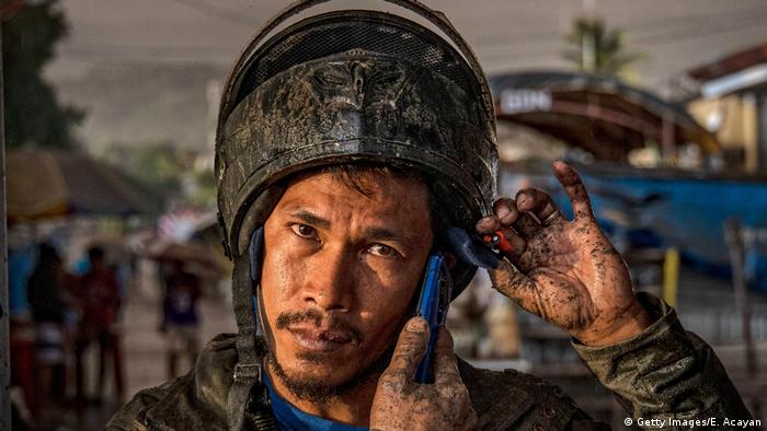 A motor cyclist on the Phillippines coveres in dust from volcanic ashes.