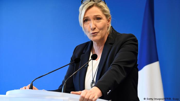 Marine le Pen speaks at a podium
