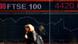 A woman walks past the British stock exchange A woman walks past the British stock exchange