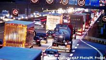 FILE - In this Tuesday, Dec. 4, 2018 file photo, trucks line up on a highway in Frankfurt, Germany. Germany's parliament is poised to more than double the starting price for carbon dioxide emissions from the transport and heating industries when the charge is introduced in 2021. (AP Photo/Michael Probst, file)