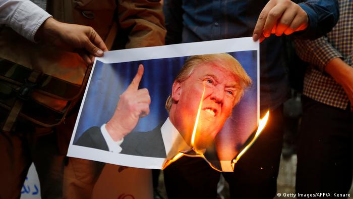 Iranians burn an image of US President Donald Trump during an anti-US demonstration outside the former US embassy headquarters in Tehran