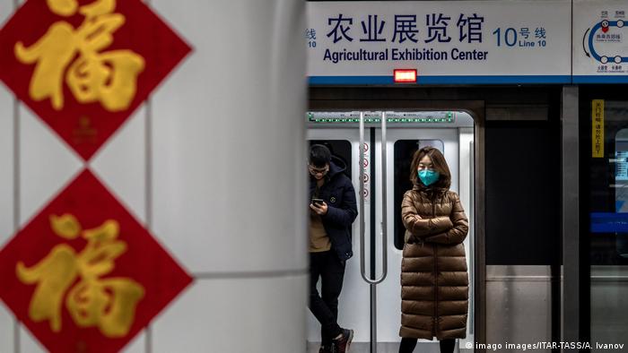 Woman in Beijing metro wears face mask 