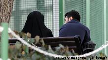 An Iranian couple sit in a park in the capital Tehran on March 14, 2017.
The Mehrieh (affection) system, in which future husbands agree to pay a certain number of gold coins to the bride in the event of divorce, has left thousands of men in Iran languishing in jail and many more destitute. / AFP PHOTO / ATTA KENARE (Photo credit should read ATTA KENARE/AFP via Getty Images)