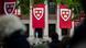 Harvard flags on a university building Harvard flags on a university building