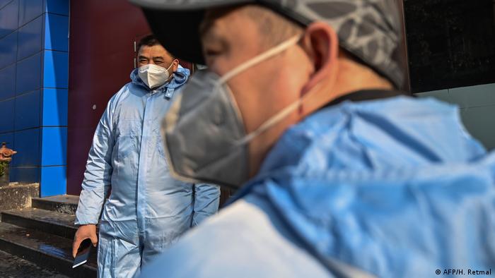 Two taxi drivers in protective clothing in Wuhan