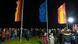 A crowd of people watches the German, European and regional flags at the geographical center in Gadheim A crowd of people watches the German, European and regional flags at the geographical center in Gadheim