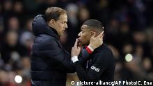 PSG's Kylian Mbappe, right, talks with PSG's head coach Thomas Tuchel during the French League One soccer match between Paris-Saint-Germain and Montpellier at the Parc des Princes stadium in Paris, Saturday Feb. 1, 2020. (AP Photo/Christophe Ena) |
