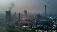 HUAINAN, CHINA - JUNE 16 2017: A Chinese state owned coal fired power plant is seen near a large floating solar farm project under construction by the Sungrow Power Supply Company on a lake caused by a collapsed and flooded coal mine on June 16, 2017 in Huainan, Anhui province, China. The floating solar field, billed as the largest in the world, is built on a part of the collapsed Panji No.1 coal mine that flooded over a decade ago due to over-mining, a common occurence in deep-well mining in China's coal heartland. When finished, the solar farm will be made up of more than 166,000 solar panels which convert sunlight to energy, and the site could potentially produce enough energy to power a city in Anhui province, regarded as one of the country's coal centers. Local officials say they are planning more projects like it, marking a significant shift in an area where long-term intensive coal mining has led to large areas of subsidence and environmental degradation. However, the energy transition has its challenges, primarily competitive pressure from the deeply-established coal industry that has at times led to delays in connecting solar projects to the state grid. Chinaâs government says it will spend over US $360 billion on clean energy projects by 2020 to help shift the country away from a dependence on fossil fuels, and earlier this year, Beijing canceled plans to build more than 100 coal-fired plants in a bid to ease overcapacity and limit carbon emissions. Already, China is the leading producer of solar energy, but it also remains the planetâs top emitter of greenhouse gases and accounts for about half of the worldâs total coal consumption. (Photo by Kevin Frayer/Getty Images)