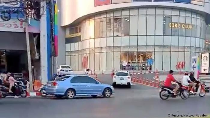 A person runs away from a shopping mall during a Thai soldier's shooting rampage in the city of Nakhon Ratchasima, Thailand 