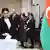 Женщина опускает бюллетень в урну на досрочных выборах в парламент Азербайджана