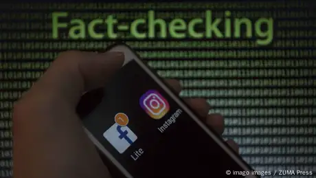 May 9 2019 Asuncion Paraguay Hand holds a smartphone displaying Facebook and Instagram logo ic