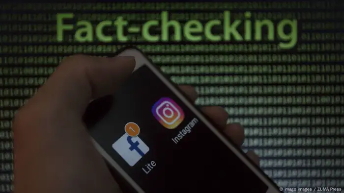 May 9 2019 Asuncion Paraguay Hand holds a smartphone displaying Facebook and Instagram logo ic
