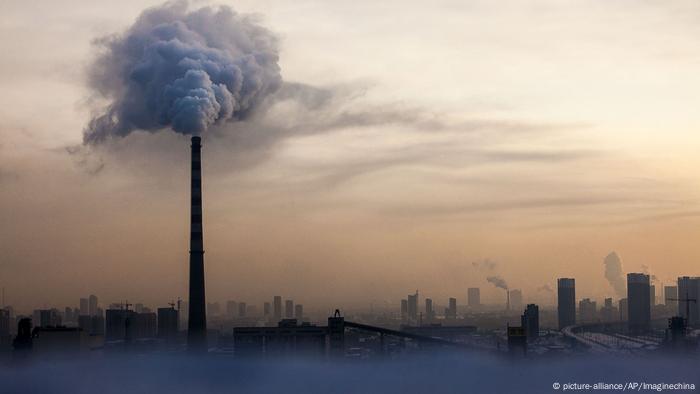 Waste gas is emitted from a chimney in heavy smog in Changchun city, in northeast China's Jilin Province