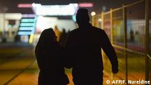 A picture taken on January 31, 2020 shows a Saudi couple walking at Riyadh's Season Boulevard in the Saudi capital. - In Saudi Arabia's rigid past, religious police once swooped down on rose sellers and anyone peddling red paraphernalia around Valentine's Day, but now a more open -- albeit risky -- dating culture is taking root. Pursuing relationships outside of marriage in the conservative Islamic kingdom once amounted to a death wish, and would-be Romeos resorted to pressing phone numbers up against their car window in hope of making contact with women. (Photo by FAYEZ NURELDINE / AFP)
